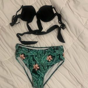Im selling this two piece swim suit. A black top and green and pink bottom.